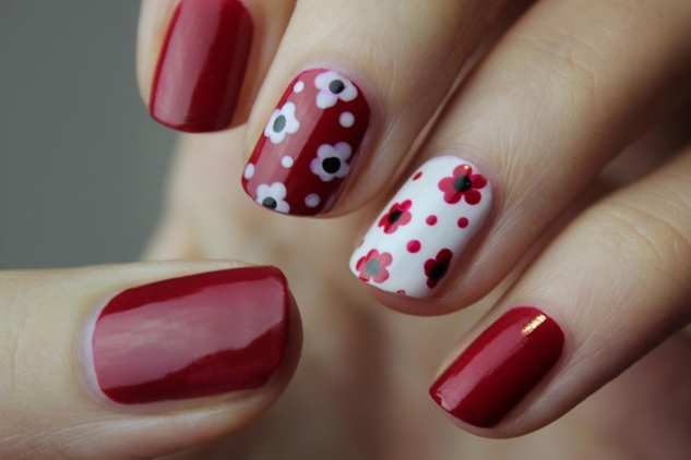 a hand with painted fingernails, each one unique from the other. Image by Yana from Pixabay